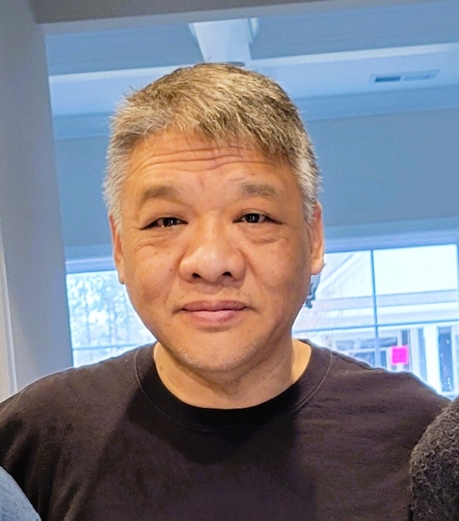 Cliff Chang, professional locksmith with 20 years of experience, standing proudly in his service area